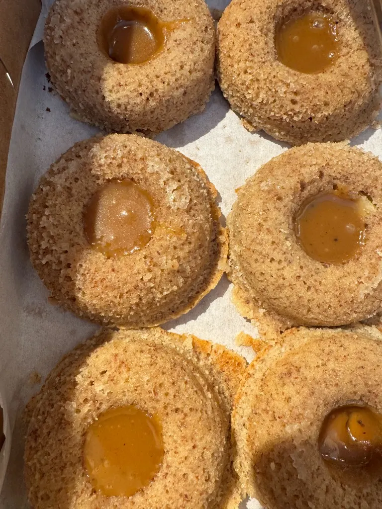 Salted caramel almond cakes lined up on parchment