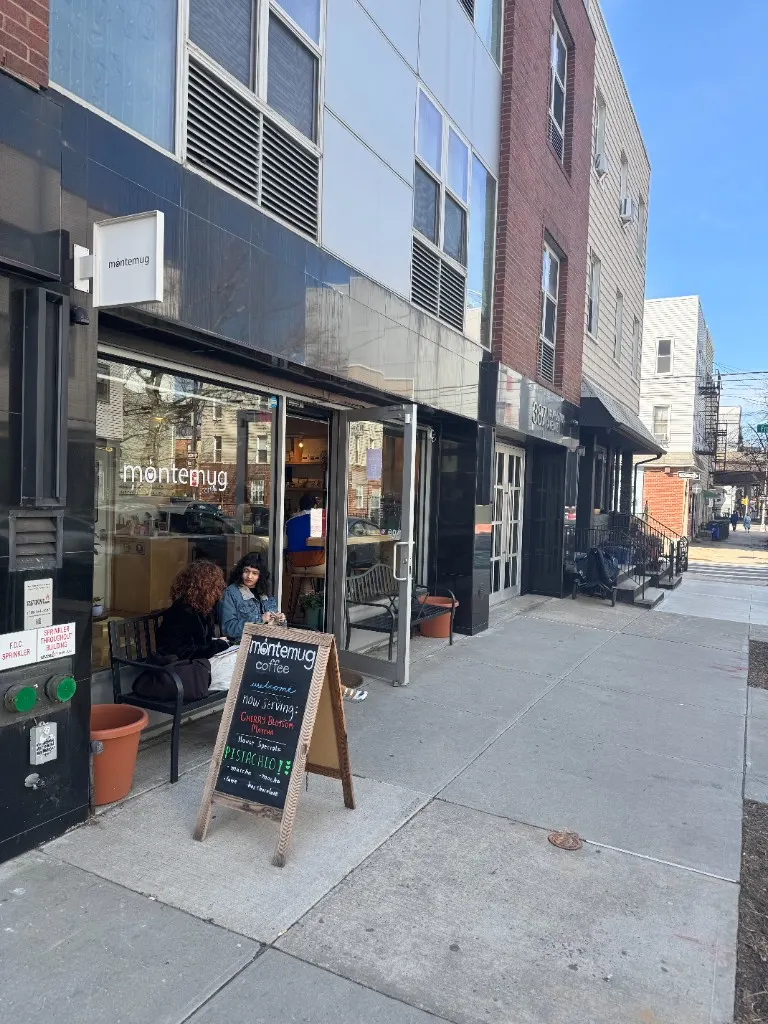 Latte art tulip in a glass on a round wooden table