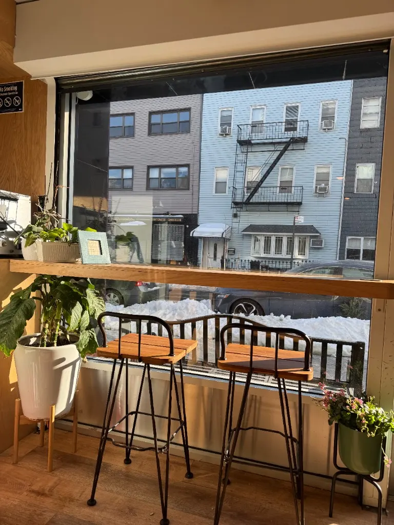 Hot chocolate in a yellow ceramic cup with a chocolate-dipped macaron